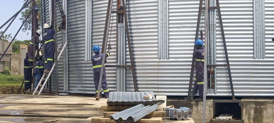 Industrial installation team working on silo cladding